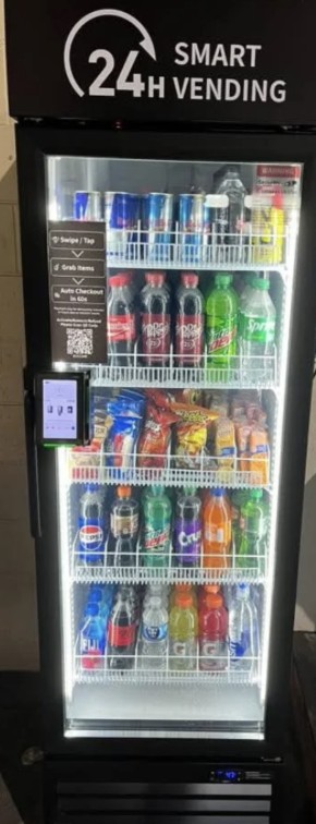 Smart vending cooler lit up and stocked with drinks and snacks